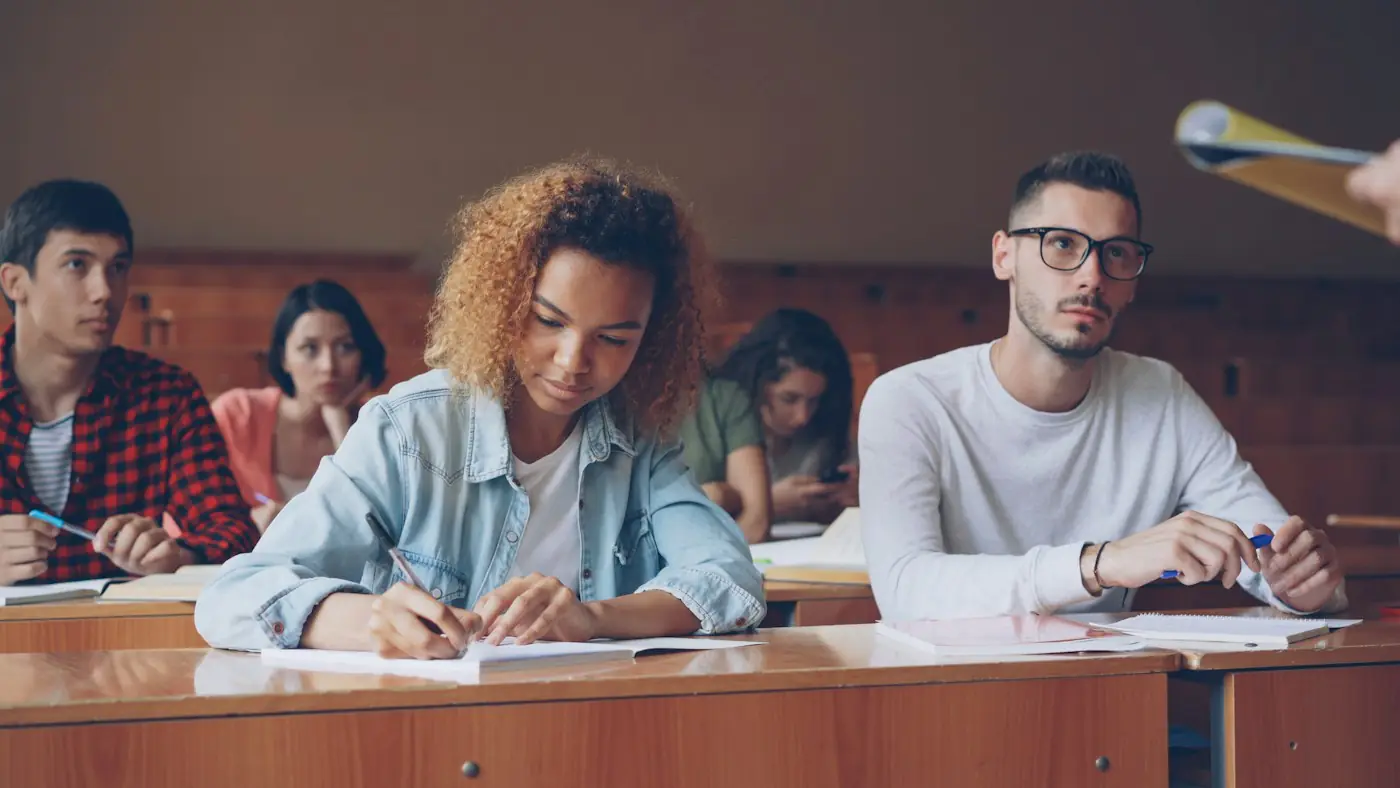 University students taking notes in a lecture hall